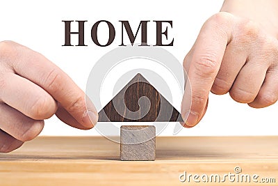 Real estate concept. Wooden house model on wooden table, white background Stock Photo