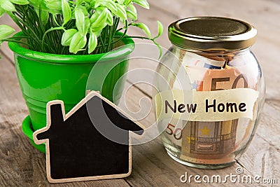 Real estate finance concept - money glass with New Home word Stock Photo