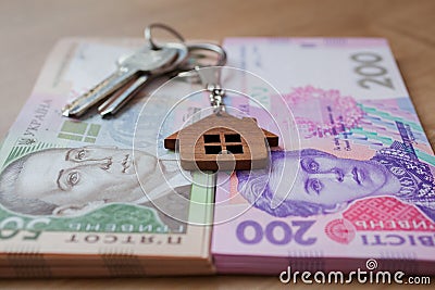 Real estate investing concept. Ukrainian hryvnia, cash or housing. Keys close up Stock Photo