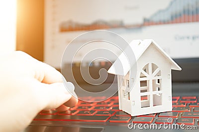 Real estate online, property agency, internet rent, mortgage credit, buying apartments via internet, house on laptop keyboard Stock Photo