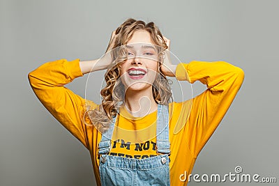 Real happy young woman smiling on gray background Stock Photo