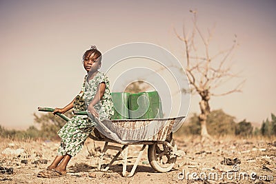 Real Indigenous Youngster Saving Healthy Water in a village Stock Photo