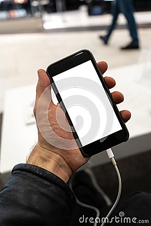 Real life use of phone in a men`s hand holding with free copy space for your ad and text - Mock up billboard and empty Stock Photo