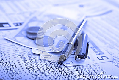 Real money over financial newspaper Stock Photo