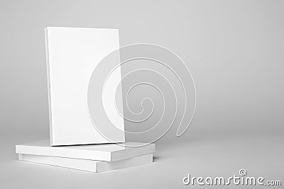 Real white book over a stack of books on a gray background Stock Photo