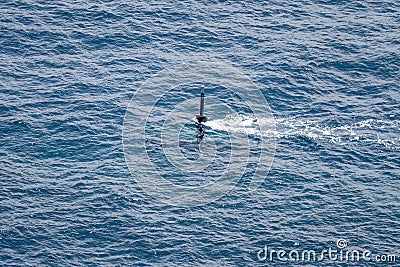 Real periscope and radio transmission mast of the attack submarine during the submarine sails in the periscope depth in the sea Stock Photo