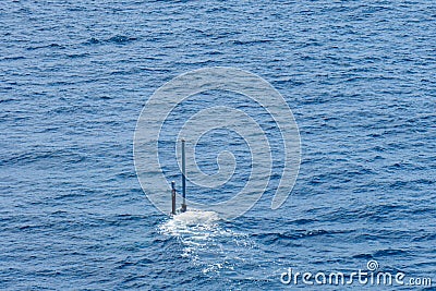 Real periscope and radio transmission mast of the attack submarine during the submarine sails in the periscope depth in the sea Stock Photo