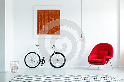 Real photo of a bike with black tires, red armchair, painting an Stock Photo