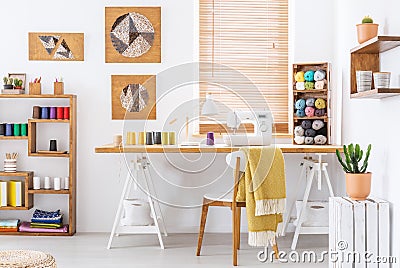 Colorful room interior with a desk, sewing machine and threads Stock Photo