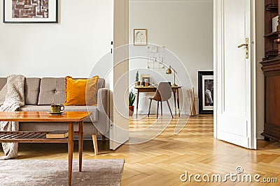 Real photo of a retro living room interior and view of a home office. View through a door Stock Photo