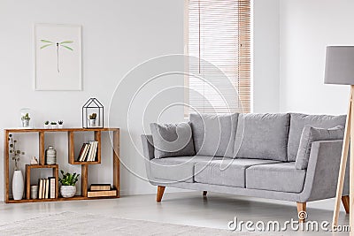 Real photo of a scandi living room interior with gray settee sta Stock Photo