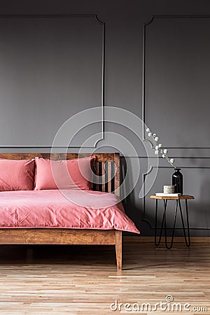 Real photo of a simple and elegant bed with dirty pink bedding n Stock Photo