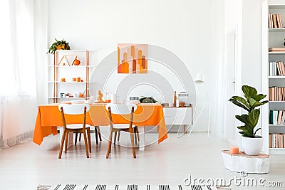 Stylish but simple dining room in vivid color. Orange and white interior design concept Stock Photo