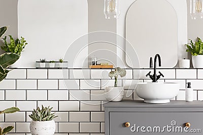 Real photo of a washbasin on a cupboard in a bathroom interior w Stock Photo