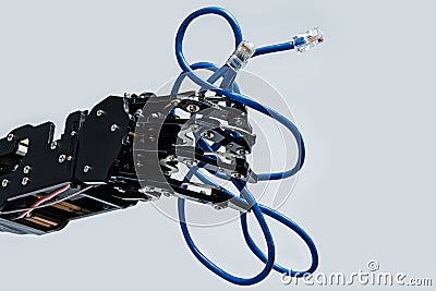 Real robot's hand holding blue Ethernet cable with rj45 connector on grey background Stock Photo