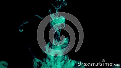 Real shot green paint drops in water. Ink swirling underwater. Cloud of ink collision isolated on black background Stock Photo