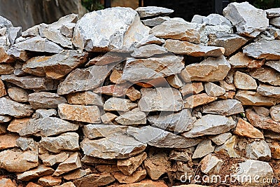 Stone wall stacked layers are uneven texture background Stock Photo