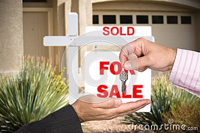 Realator handing over keys Stock Photo