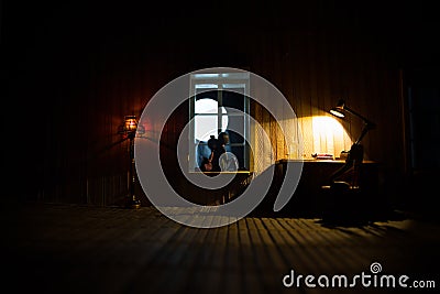 A realistic dollhouse living room with furniture and window at night. Artwork table decoration with handmade realistic dollhouse Stock Photo