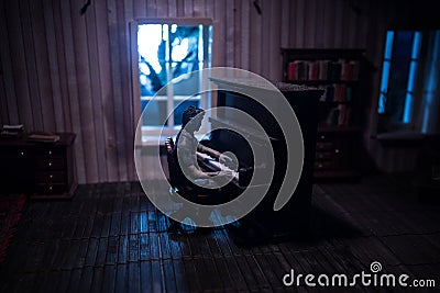A realistic dollhouse living room with furniture and window at night. Artwork table decoration with handmade realistic dollhouse Stock Photo