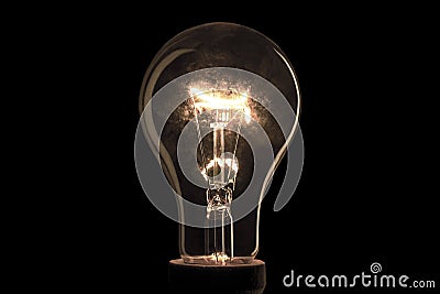 Realistic electric light bulb on black background. Stock Photo