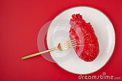 Realistic heart on the dining table in the plate Stock Photo