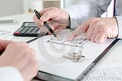 Realtor giving explanations to his client Stock Photo