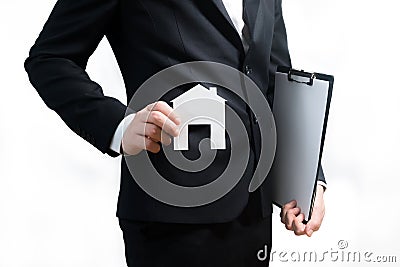 Realtor, real estate agent holding tablet and paper model of a h Stock Photo