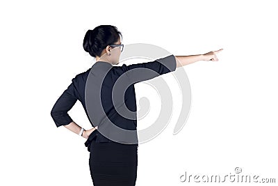 Rear / Back view of business woman standing and pointing. Stock Photo