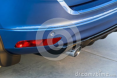 Rear bumper of a car with exhaust pipe, modern car exterior details. Stock Photo