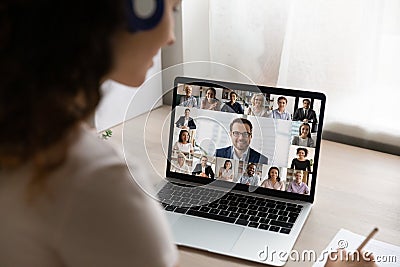 Rear view of female employee have online meeting on laptop Stock Photo