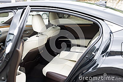 Rear leather passenger seats in modern lux car. White leather car passenger seat. Control unit with electric seat Stock Photo