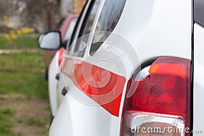 The rear left lamp of a white car is broken. The taillight of the car was shattered in the accident. Damage accident. Security Stock Photo