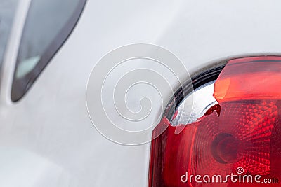 The rear left lamp of a white car is broken. The taillight of the car was shattered in the accident. Damage accident. Security Stock Photo