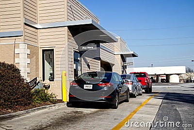 Rear of a line of cars in McDonalds drive thru Editorial Stock Photo