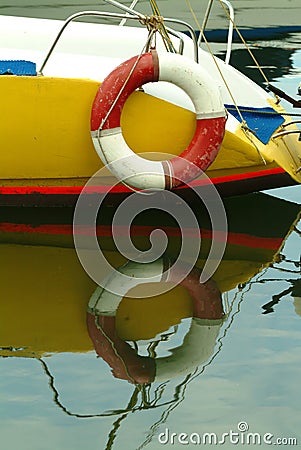 Rear part of a boat with life ring attached,nice water reflections Stock Photo