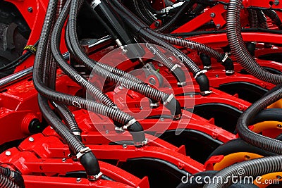 Rear part of modern Swedish pneumatic seed drill Vaderstad Spirit 400 C, with visible grain tubes, covering discs. Editorial Stock Photo