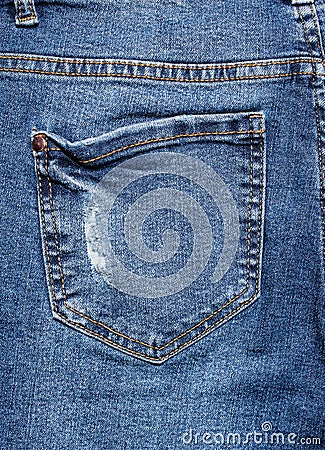 Rear pocket of torn worn jeans. Stock Photo