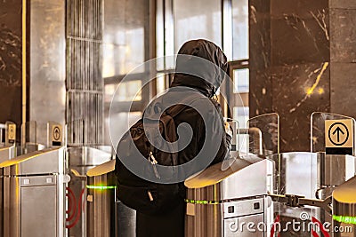 rear portrait of person go through security turnstile b Stock Photo