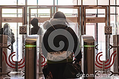 rear portrait of person go through security turnstile b Stock Photo