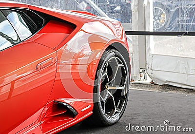 Rear rim and wing of a beautiful orange Lamborghini Huracan on a sunny day Editorial Stock Photo