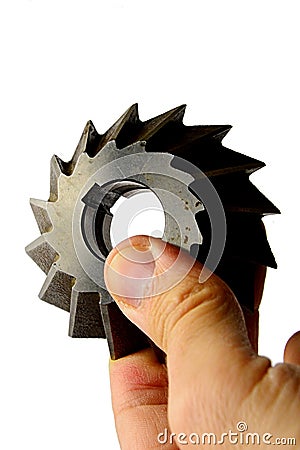 Single angle milling cutter with securing groove on internal diameter, slightly used, held in left hand on white background Stock Photo