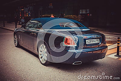 Rear side view of a very expensive premium Rolls-Royce Dawn car, luxury dark blue convertible Editorial Stock Photo