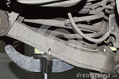 The rear suspension arm is supported by a hydraulic rack Stock Photo