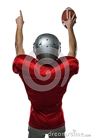 Rear view of American football player with arms raised Stock Photo