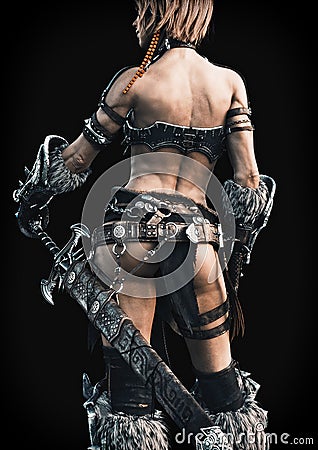 Rear view of an armed female warrior on a black background. Stock Photo