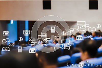 Rear view of audience attending meeting business seminar in conference room With Social Icons Stock Photo