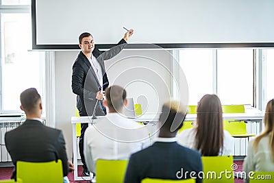 Rear view of Audience in the conference hall or seminar meeting which have Speakers on the stage, business and education about Stock Photo