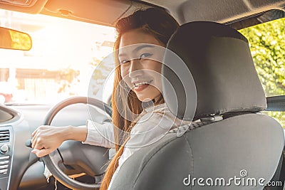 Rear view Beautiful attractive young woman smile in casual sitting in car Stock Photo