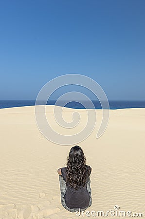 Rear View of brunette woman doing yoga Stock Photo